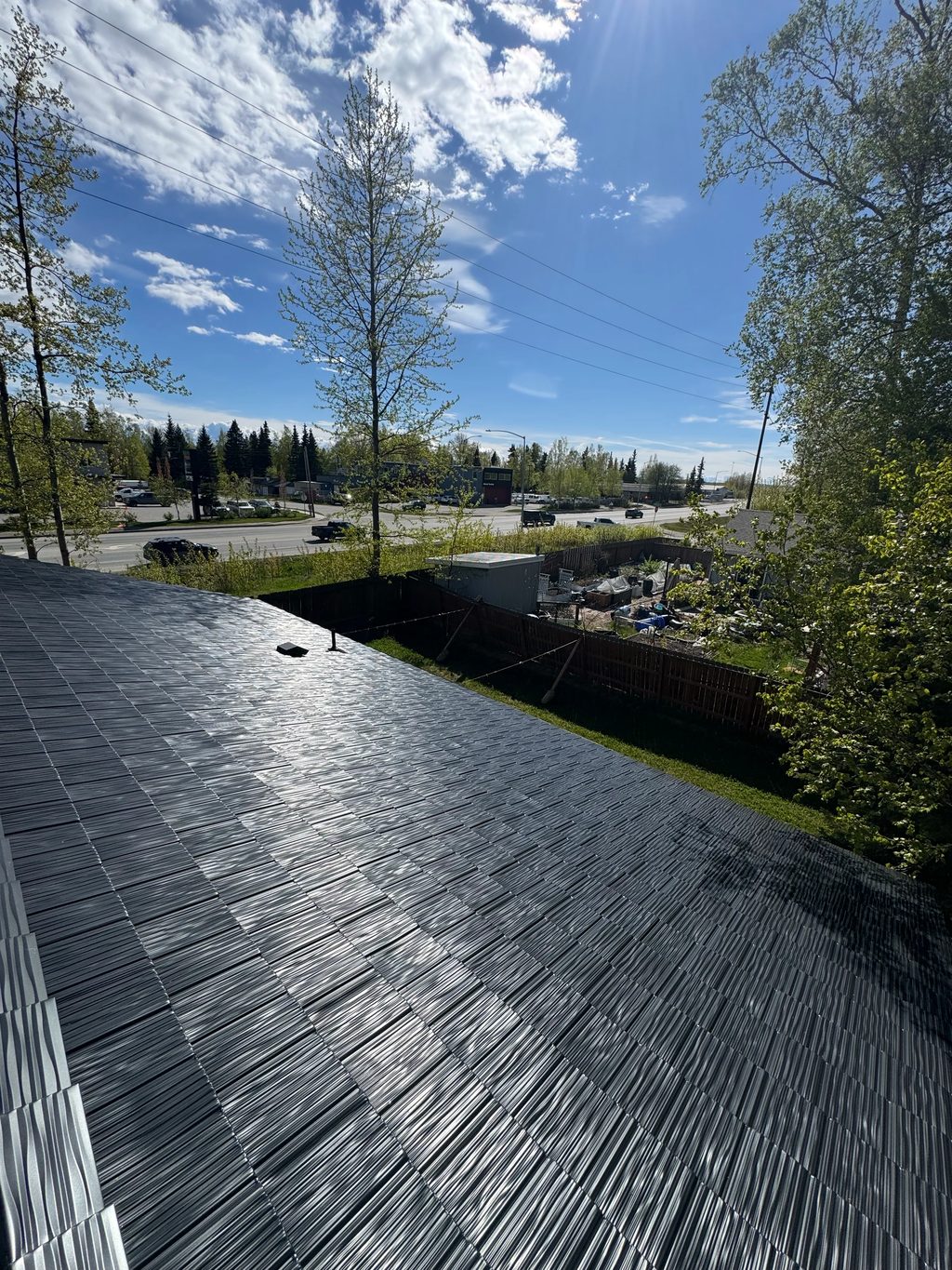 Black Interlock Shake aluminum roof on a black home with a metal roof in a wooded area, Anchorage, Alaska