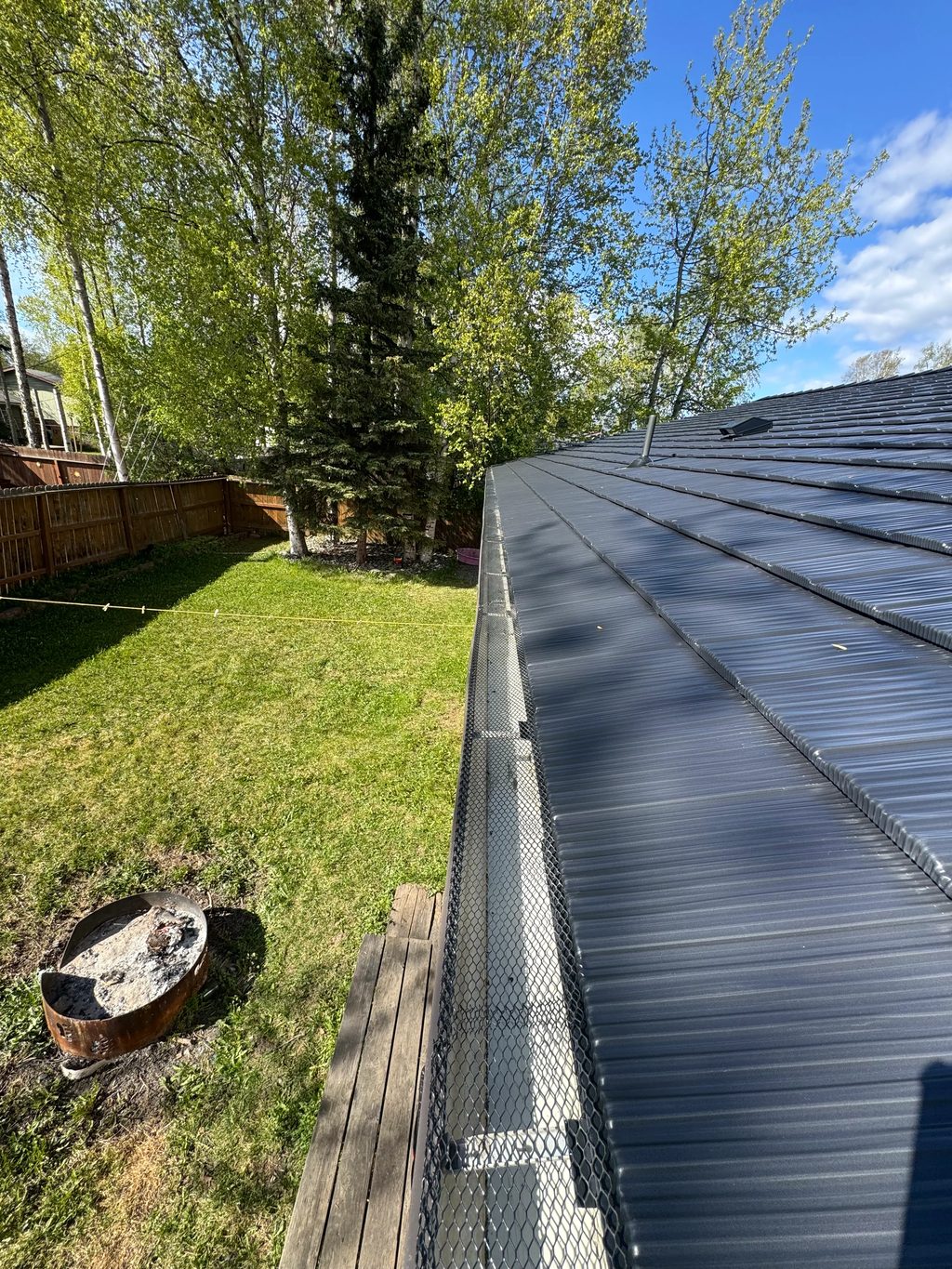 A black metal roof on a suburban home.