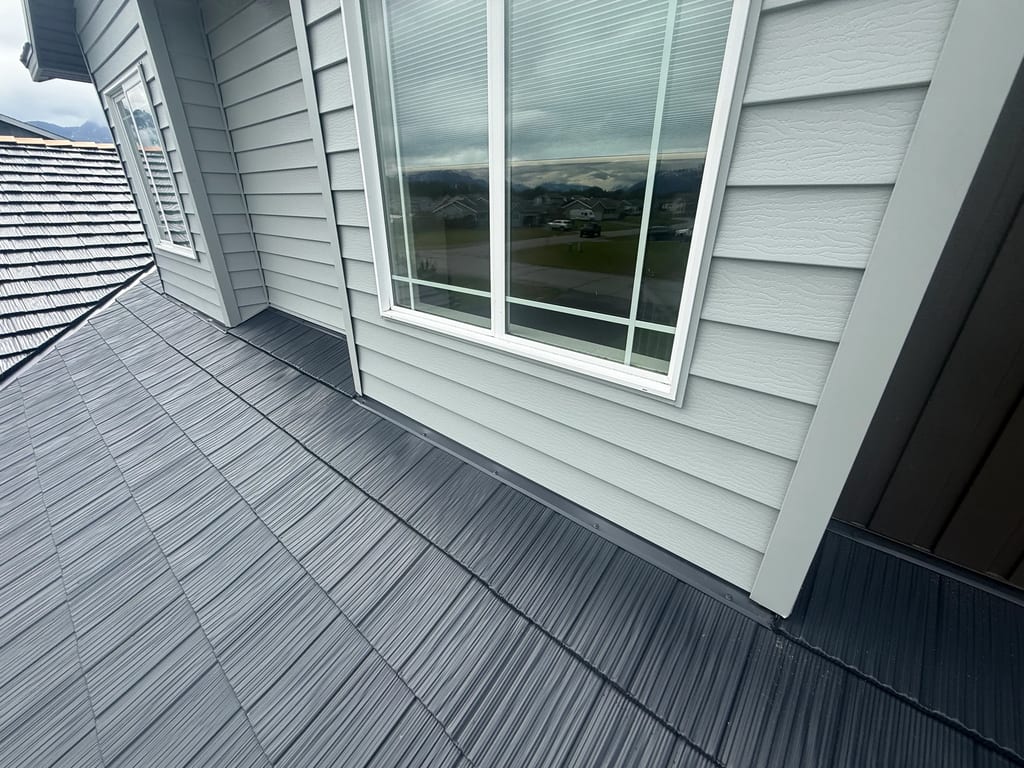 A modern metal roof on a single-family home in an urban setting.