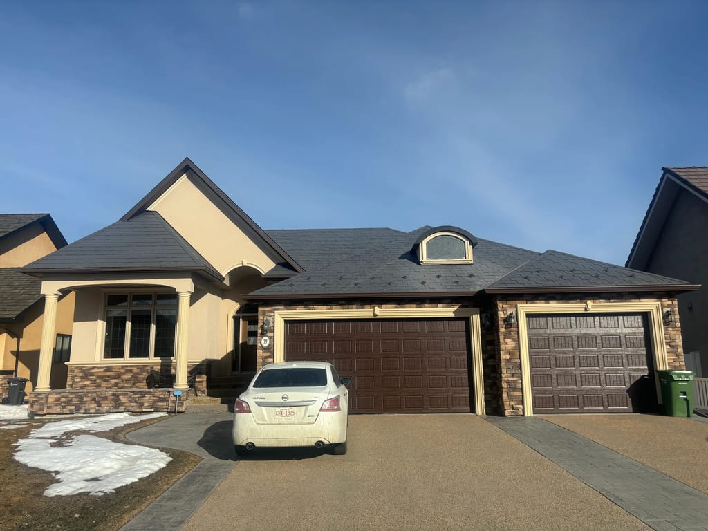 Charcoal Grey Interlock Slate aluminum roof on a beige bungalow with a metal roof in a rural suburban, Red Deer, Alberta
