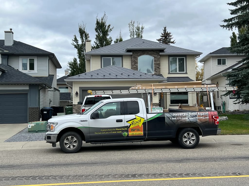 Charcoal Grey Interlock Slate aluminum roof on a beige two-storey home with a metal roof in Calgary,, Calgary, Alberta