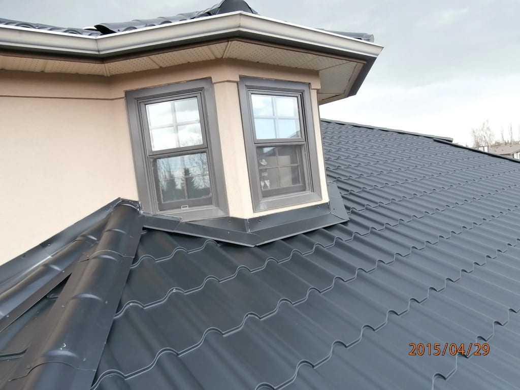 Black Interlock Tile aluminum roof on a black one-storey home with a metal roof in a suburban, Calgary, Alberta