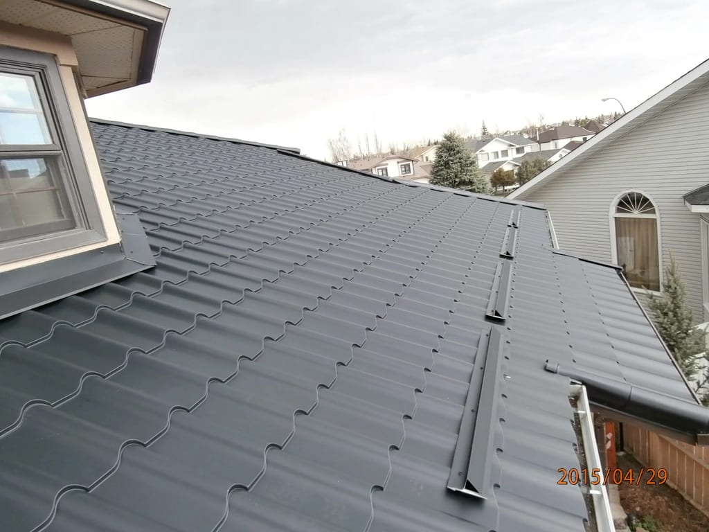 Black Interlock Tile aluminum roof on a white single-family home with a black metal roof in a, Calgary, Alberta