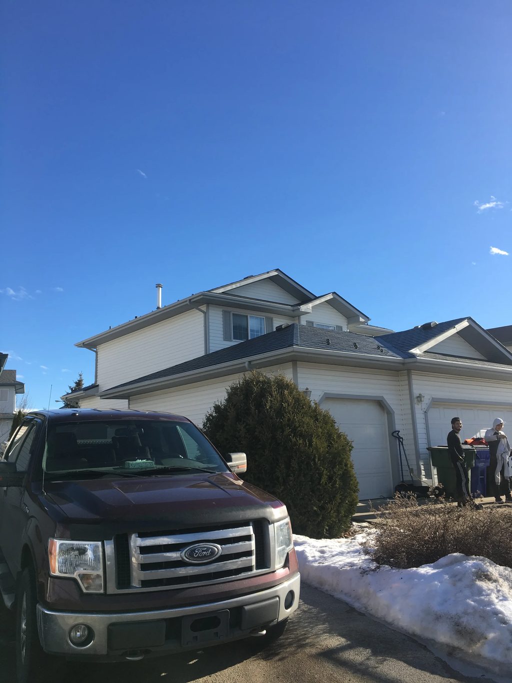 Deep Charcoal Interlock Slate aluminum roof on a white house with a garage and a large tree in the front, Fort Saskatchewan, Alberta