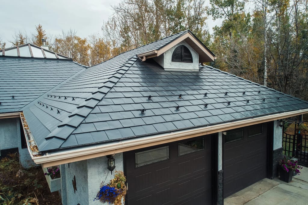 Black Interlock Slate aluminum roof on a black single-family home with dormers among tall trees, Spruce Grove, Alberta