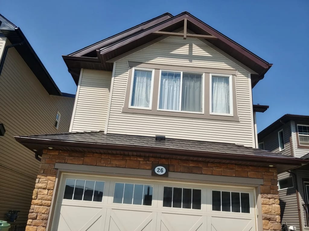 Tudor Brown Interlock Slate aluminum roof on a Tudor brown two-storey home with dormers in a suburban, Calgary, Alberta