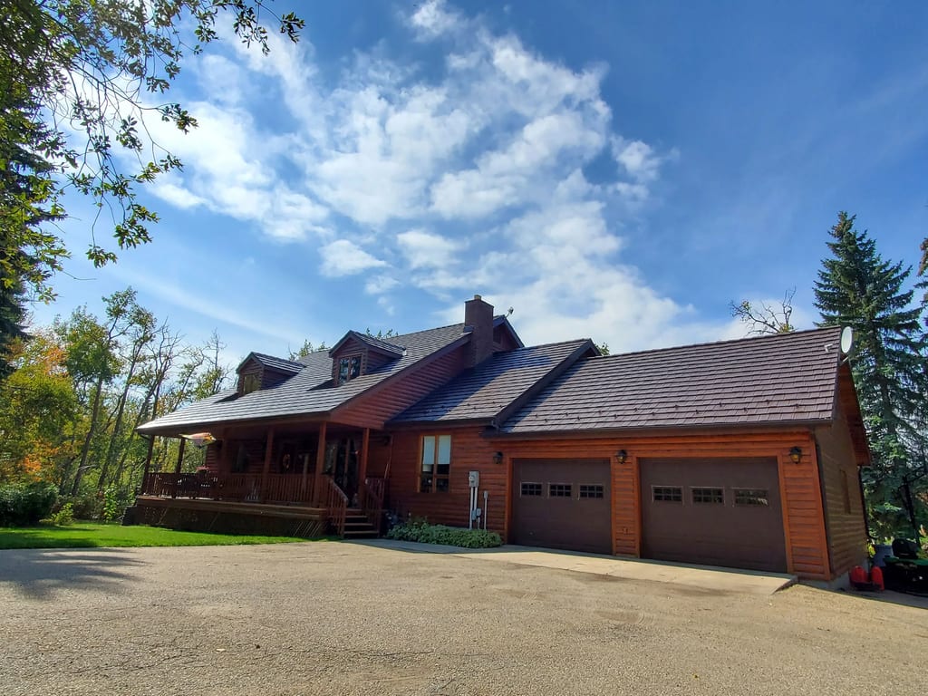 Colonial Brown Interlock Shake aluminum roof on a brown two-storey home with a garage in a rural setting, Red Deer County, Alberta