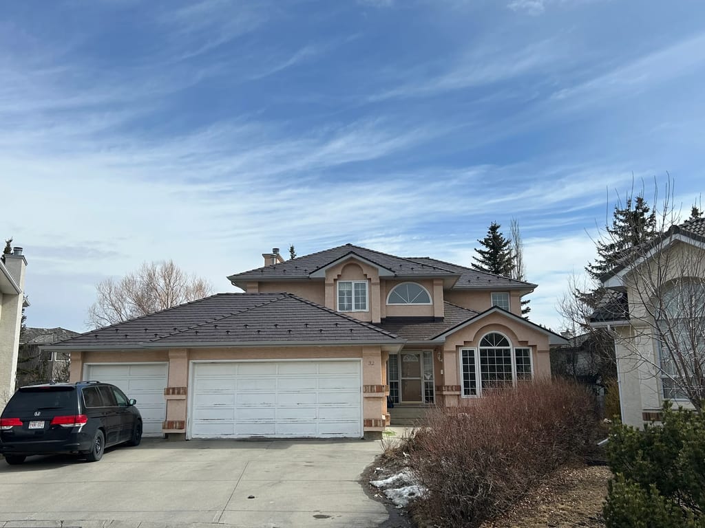 Colonial Brown Interlock Slate aluminum roof on a two-storey home with dormers in a mountainous suburban, Calgary, Alberta