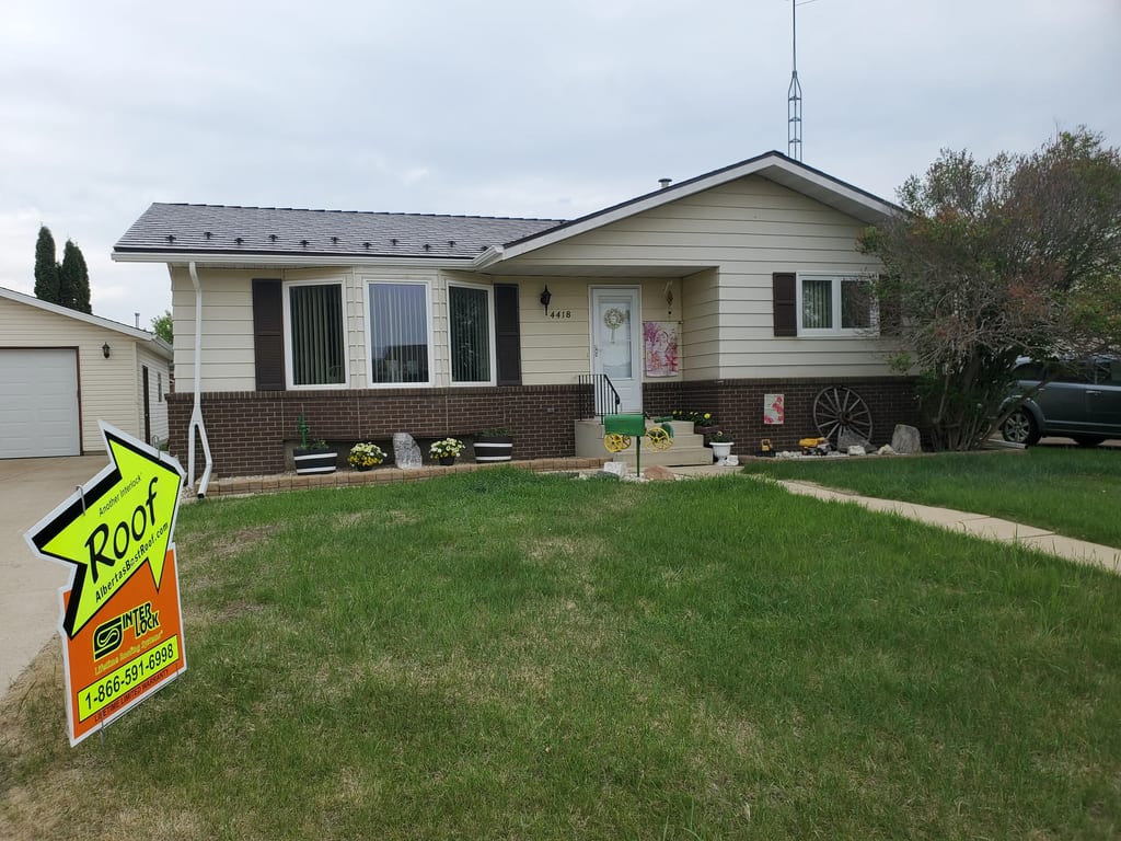 Colonial Brown Interlock Slate aluminum roof being installed on a Colonial brown metal roof on a single-storey rural home, Vegreville, Alberta