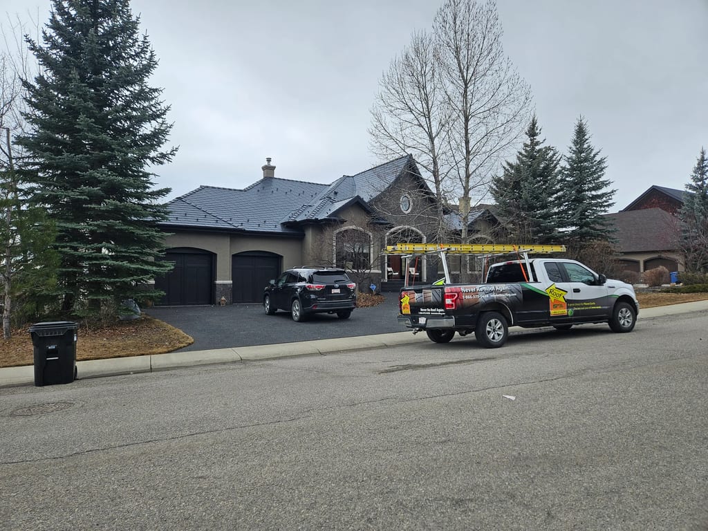 Deep Charcoal Interlock Slate aluminum roof on a two-storey home with a metal roof in a residential area, Calgary, Alberta