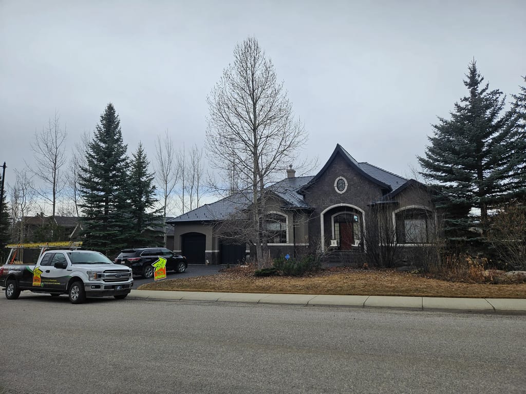 Deep Charcoal Interlock Slate aluminum roof on a grey one-storey home with dormers in the mountains, Calgary, Alberta