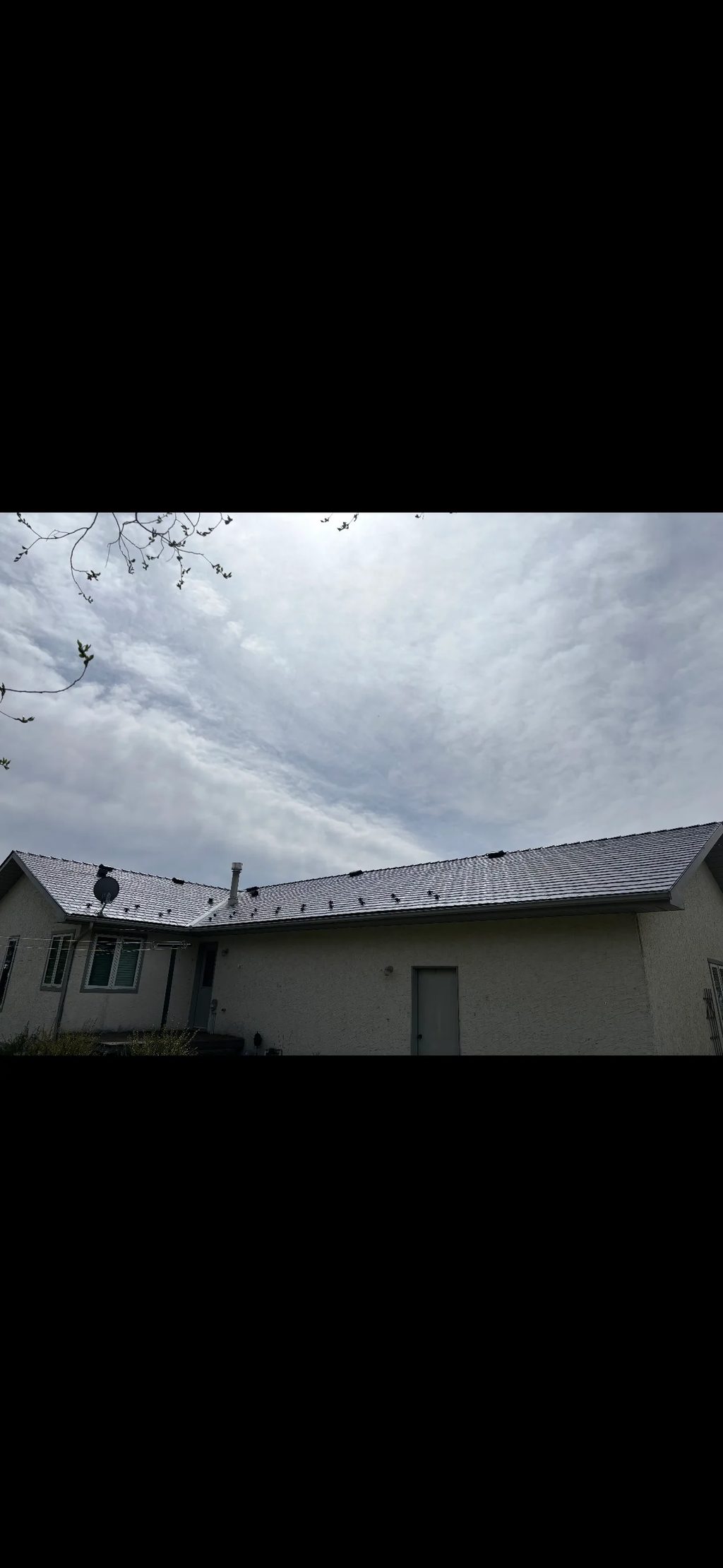 Deep Charcoal Interlock Slate aluminum roof on a beige one-storey home with dormers in a rural setting, Red Deer County, Alberta