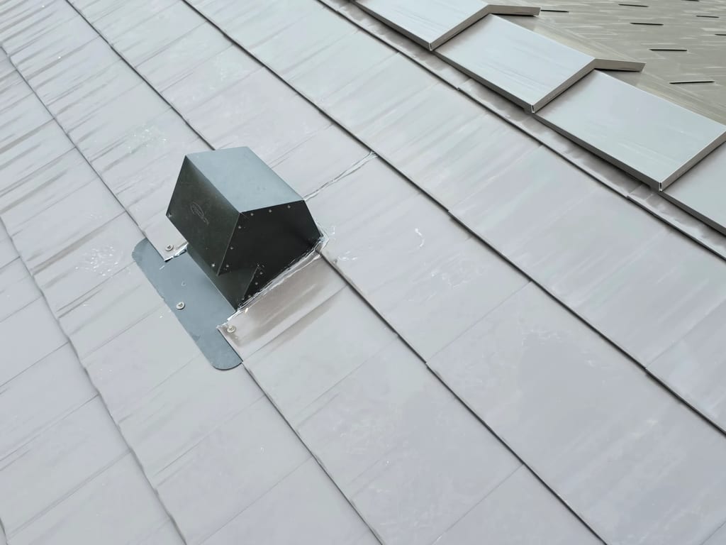 Tudor Brown Interlock Cedar Shingle aluminum roof on a Tudor-style home with a metal roof in the mountains, Rocky Mountain House, Alberta