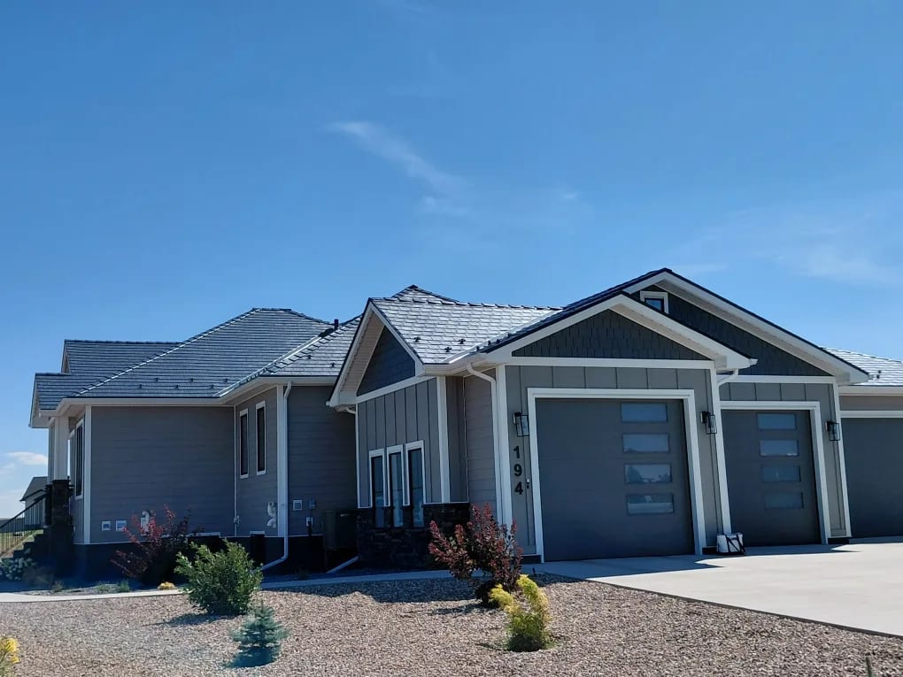 Deep Charcoal Interlock Slate aluminum roof on a grey ranch-style home with a metal roof in a rural area, Dunmore, Alberta