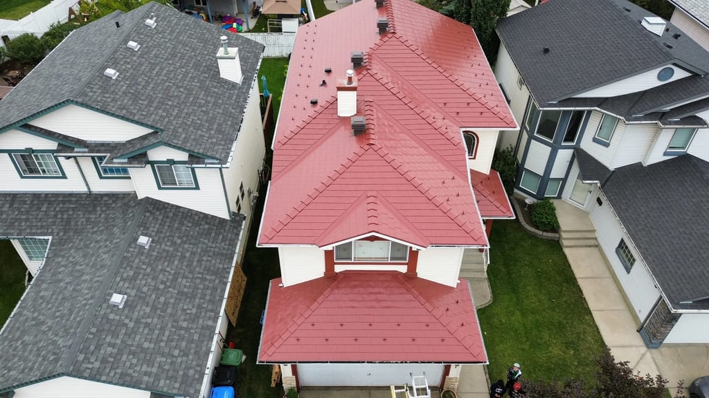 Tile Red Interlock Slate aluminum roof on a two-storey home with a red metal roof in a suburban, Calgary, Alberta