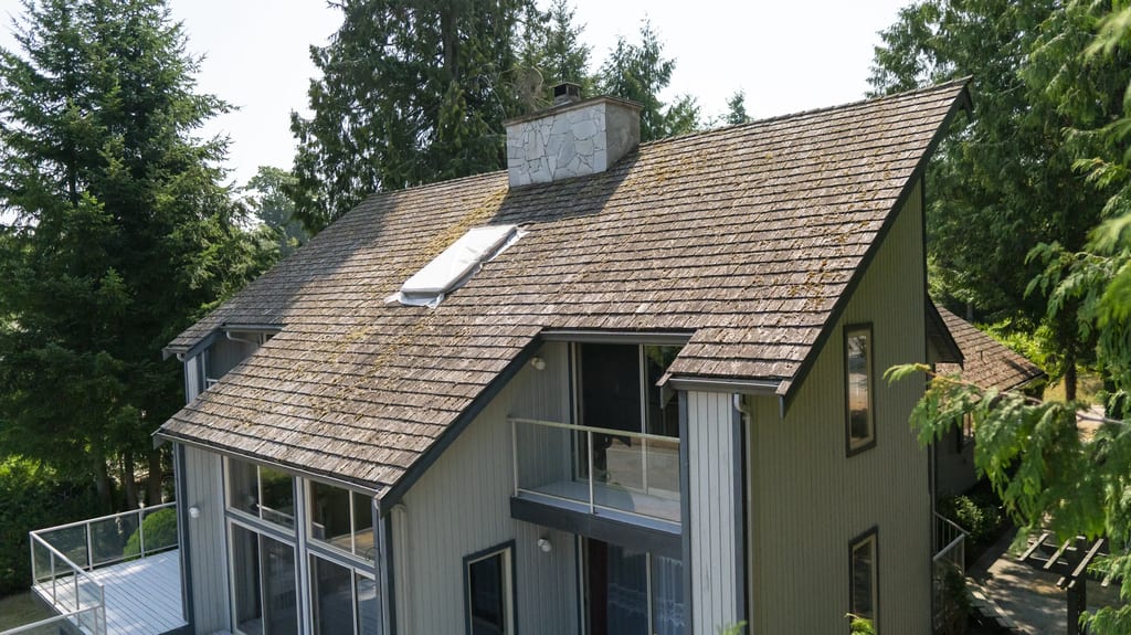 Before: a mossy wood shake roof on the home, Sechelt, British Columbia, ahead of a Deep Charcoal Interlock Slate aluminum roof