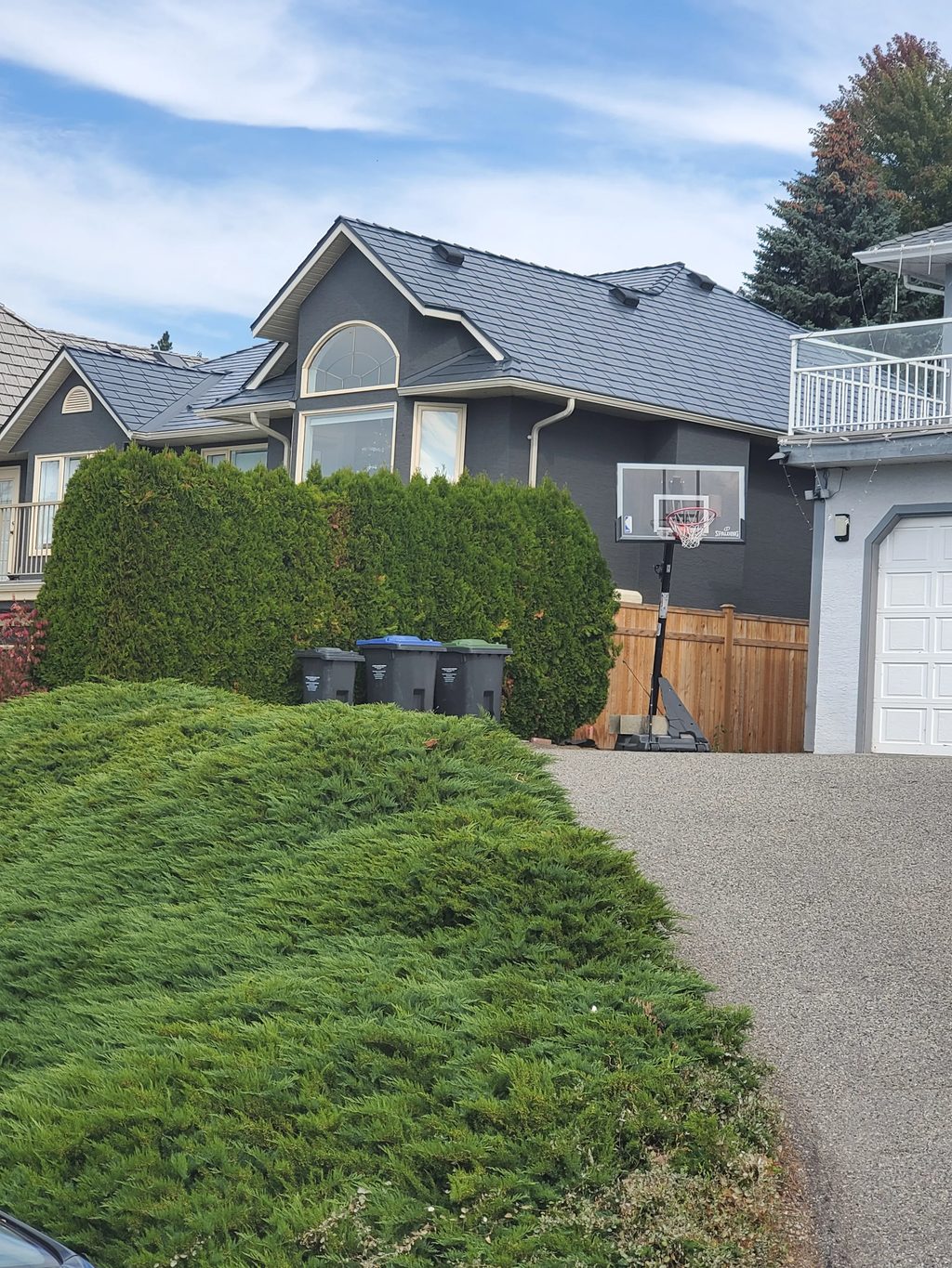 Deep Charcoal Interlock Slate aluminum roof on a two-storey home with a metal roof in Deep Charcoal among, Kelowna, British Columbia