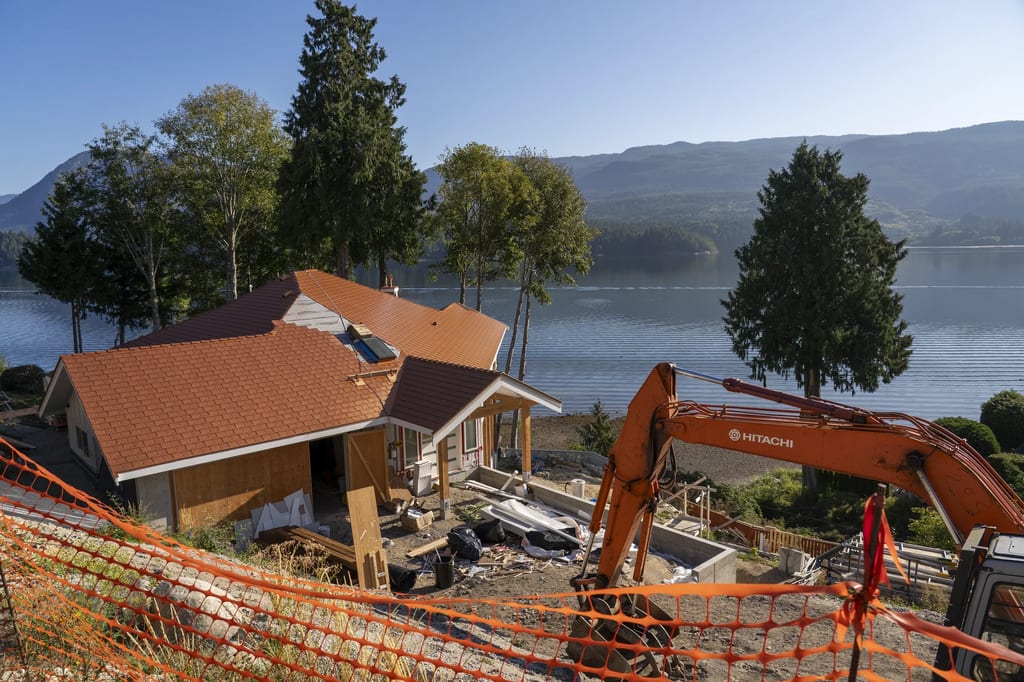 Copper Penny Interlock Slate aluminum roof being installed on the home, replacing new construction, Sechelt, British Columbia
