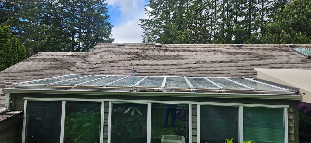 Before: a mossy asphalt shingle roof on the home, Squamish, British Columbia, ahead of a Tudor Brown Interlock Slate aluminum roof