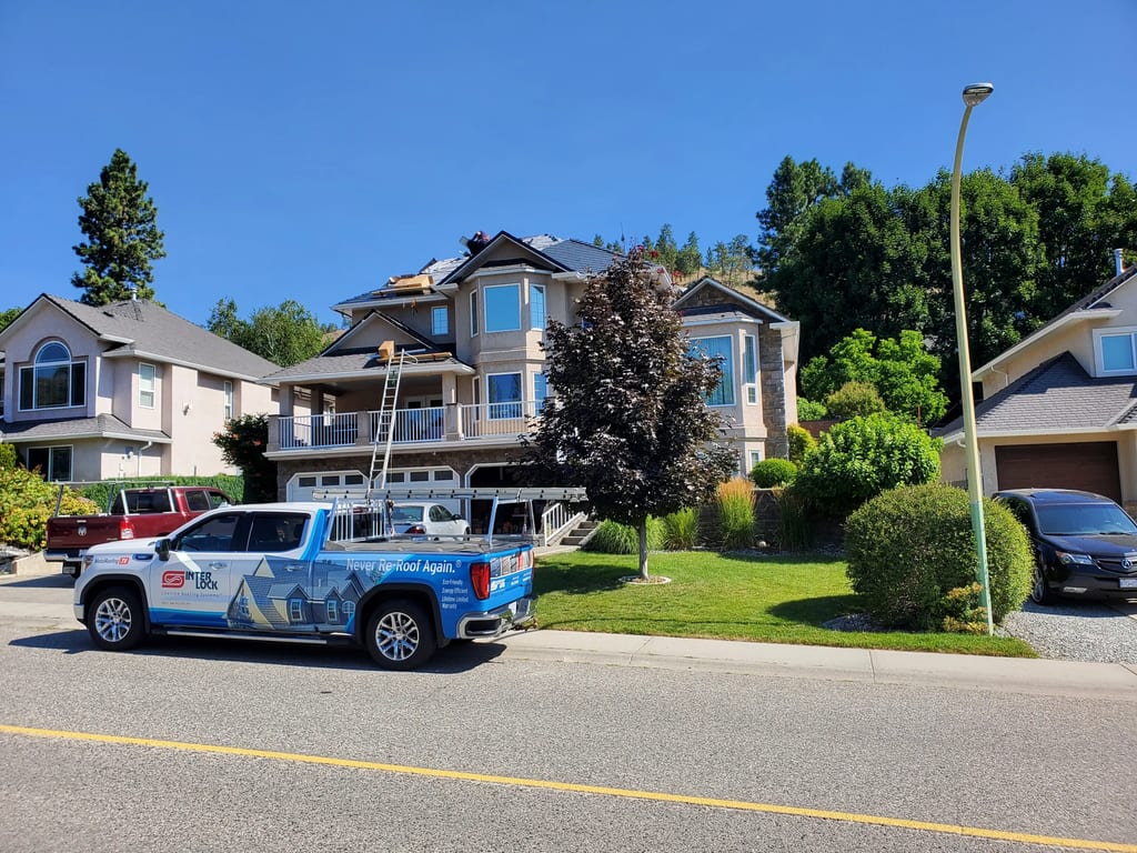 Deep Charcoal Interlock Slate aluminum roof being installed on the home, replacing a worn out asphalt shingle roof, Kelowna, British Columbia