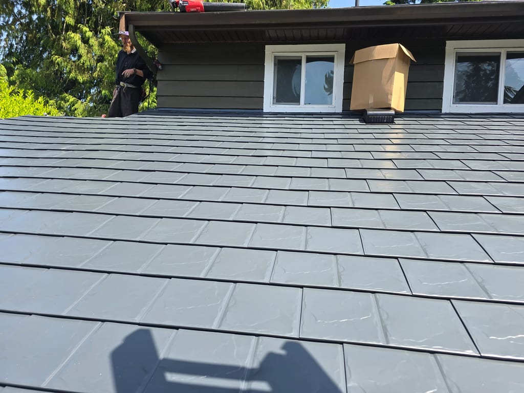 Deep Charcoal Interlock Slate aluminum roof on a deep charcoal single-family home with a metal roof among, Sechelt, British Columbia