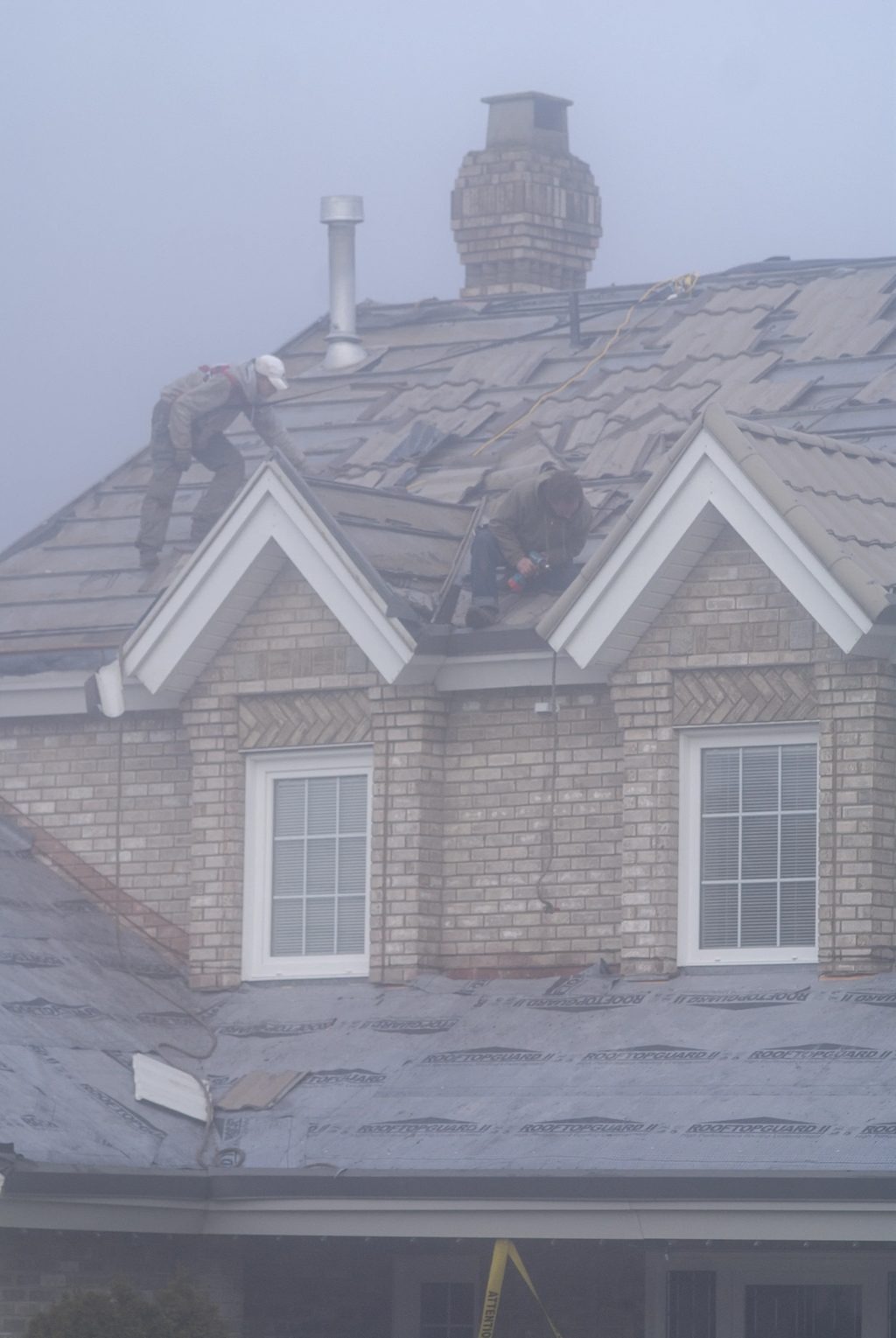 Black Interlock Slate aluminum roof being installed on the home, replacing an asphalt shingle roof being torn off, Surrey, British Columbia