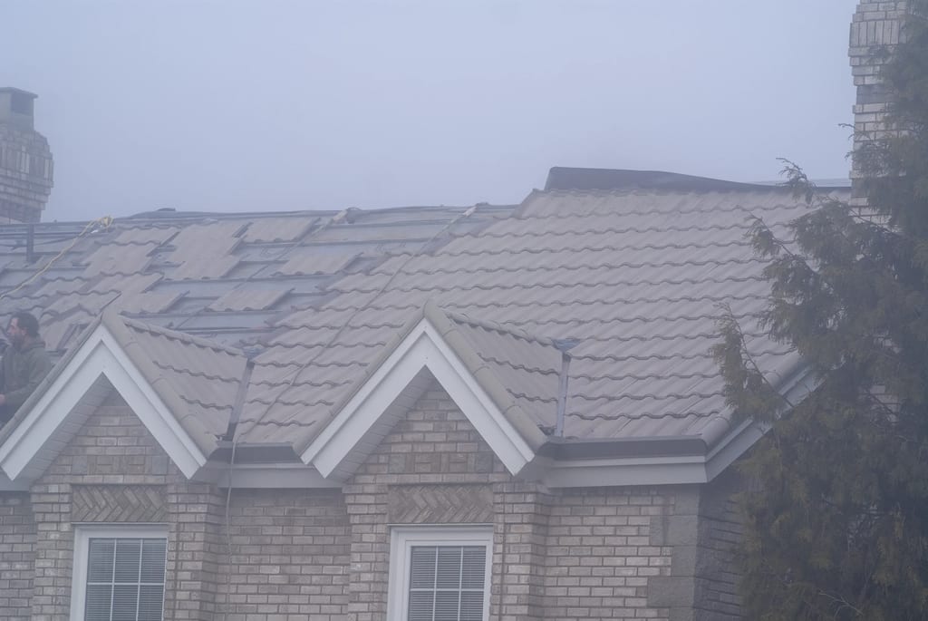 Black Interlock Slate aluminum roof being installed on the home, replacing a worn out metal roof, Surrey, British Columbia