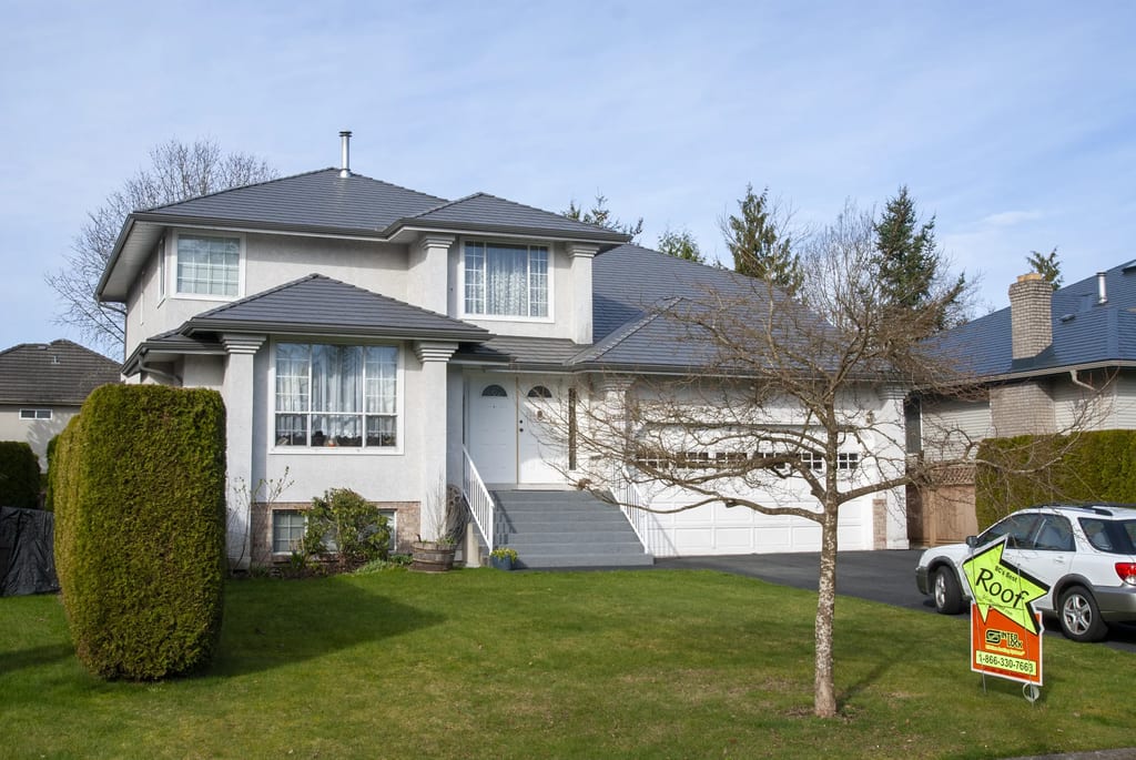 Musket Grey Interlock Slate aluminum roof on a two-storey home with a grey metal roof in a suburban, Surrey, British Columbia