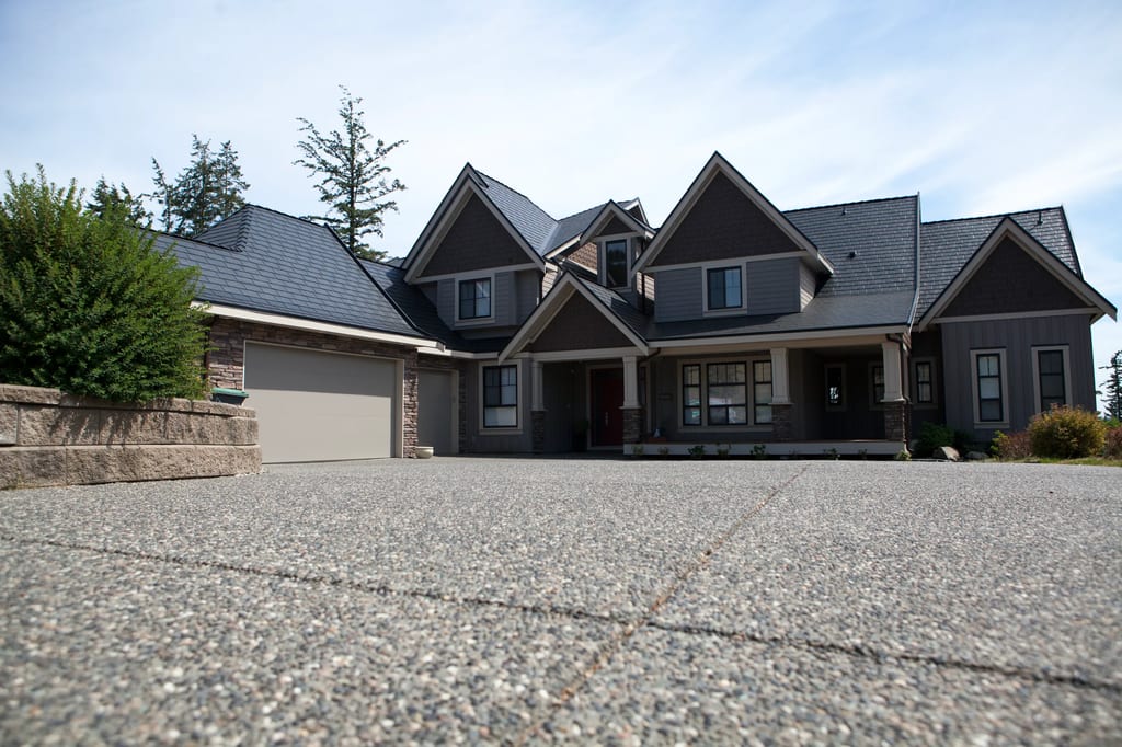 Black Interlock Slate aluminum roof on a dark grey home with two storeys and a gable roof in a, Surrey, British Columbia