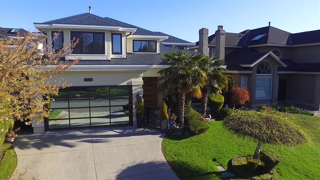 Deep Charcoal Interlock Slate aluminum roof on a two-storey modern home with a metal roof and palm trees, Richmond, British Columbia