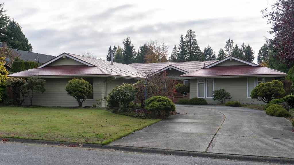Tile Red Interlock Slate aluminum roof on a ranch home in a suburban setting with lush greenery, Delta, British Columbia