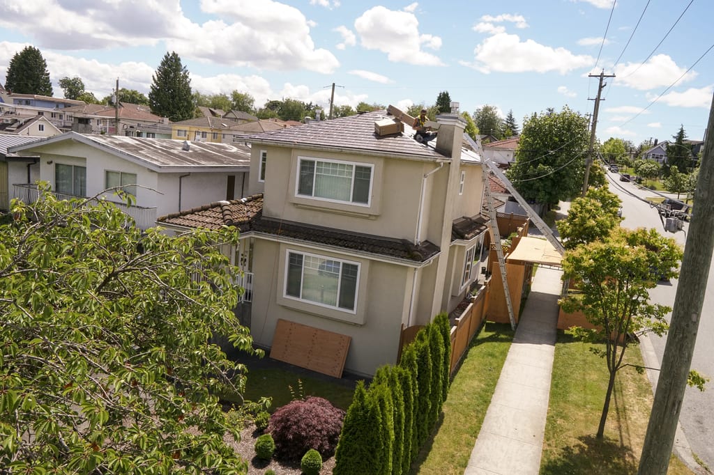Colonial Brown Interlock Slate aluminum roof being installed on the home, replacing a cracked concrete tile roof, Vancouver, British Columbia