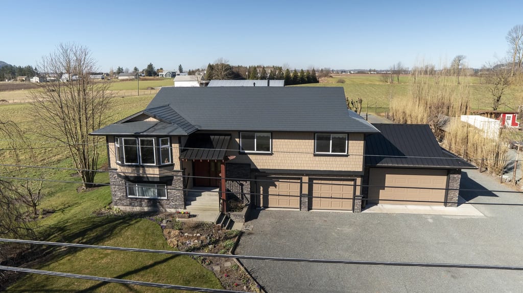 Deep Charcoal Interlock Slate aluminum roof on a two-storey home with a metal roof in a rural setting, Abbotsford, British Columbia