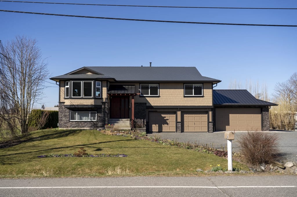 Deep Charcoal Interlock Slate aluminum roof on a brown two-storey home with a metal roof in rural, Abbotsford, British Columbia