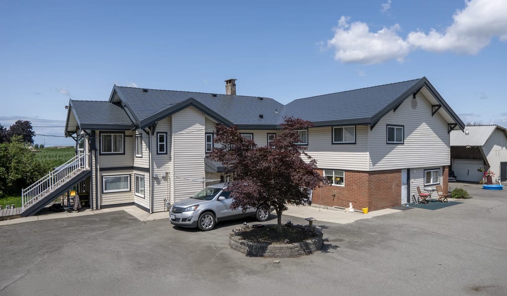 Deep Charcoal Interlock Slate aluminum roof on a two-storey home with a metal roof in a residential area, Delta, British Columbia