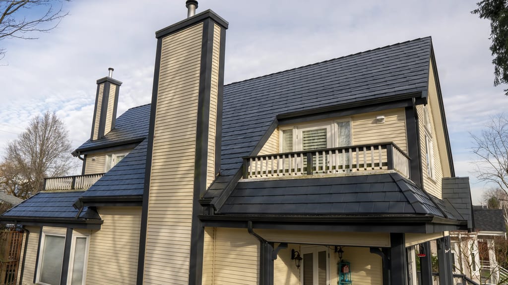 Deep Charcoal Interlock Slate aluminum roof on a beige single-storey craftsman home with a balcony among, Vancouver, British Columbia