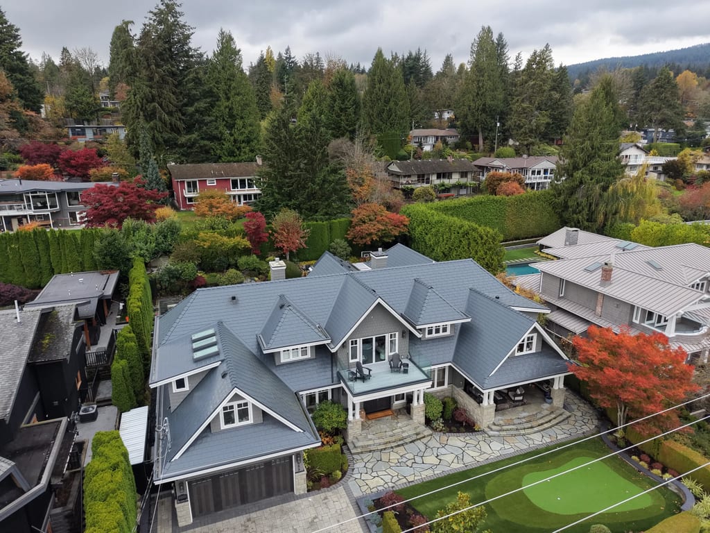 Deep Charcoal Interlock Slate aluminum roof on a modern home with a metal roof in a forested suburban, North Vancouver, British Columbia