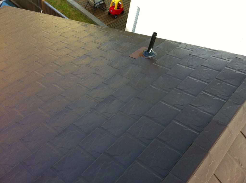 Colonial Brown Interlock Slate aluminum roof on a Colonial Brown metal roof on a two-storey home in a, Campbell River, British Columbia