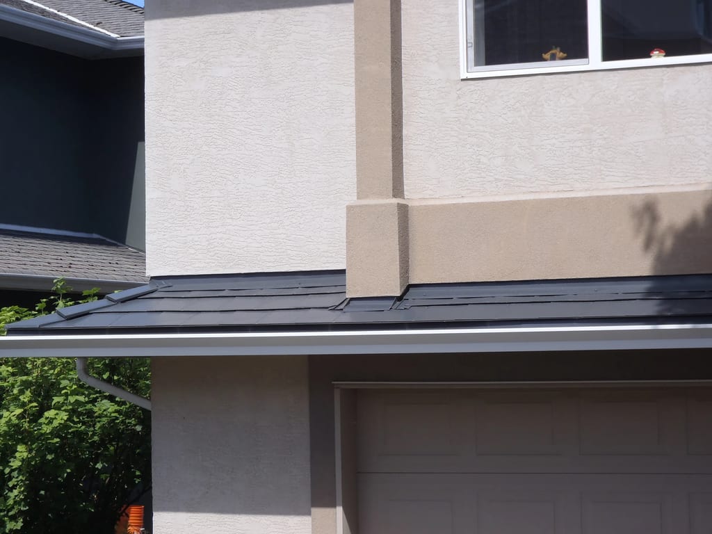 Deep Charcoal Interlock Slate aluminum roof on a modern home with a metal roof in progress in a suburban, Victoria, British Columbia