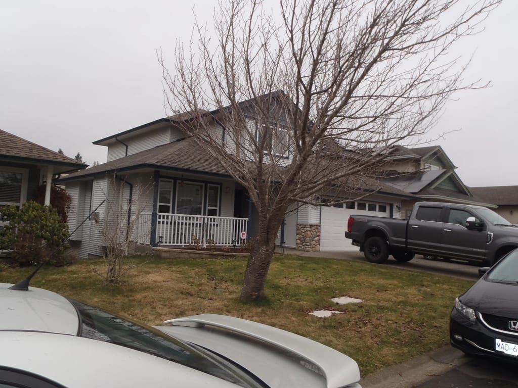 Before: a leaking asphalt shingle roof on the home, Sooke, British Columbia, ahead of a Black Interlock Slate aluminum roof