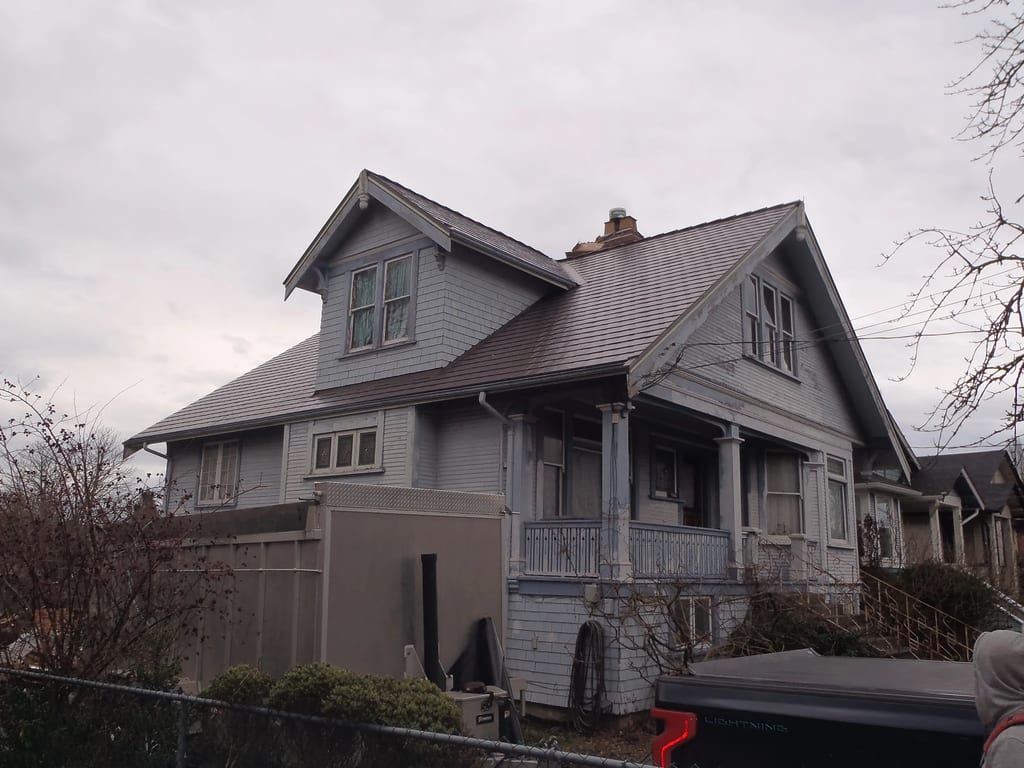 Tudor Brown Interlock Cedar Shingle aluminum roof on a Tudor home with a metal roof in an urban setting, Victoria, British Columbia