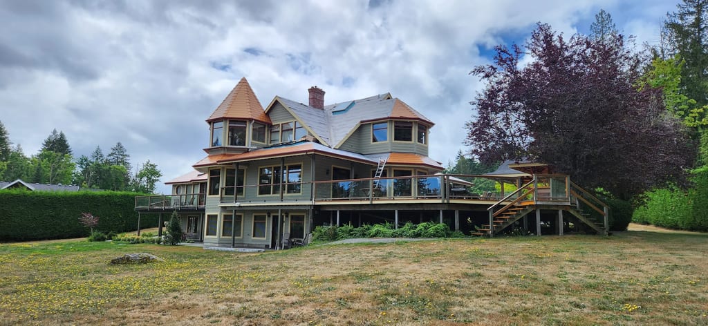 Copper Penny Interlock Slate aluminum roof being installed on the home, replacing a worn out wood shake roof, Ladysmith, British Columbia