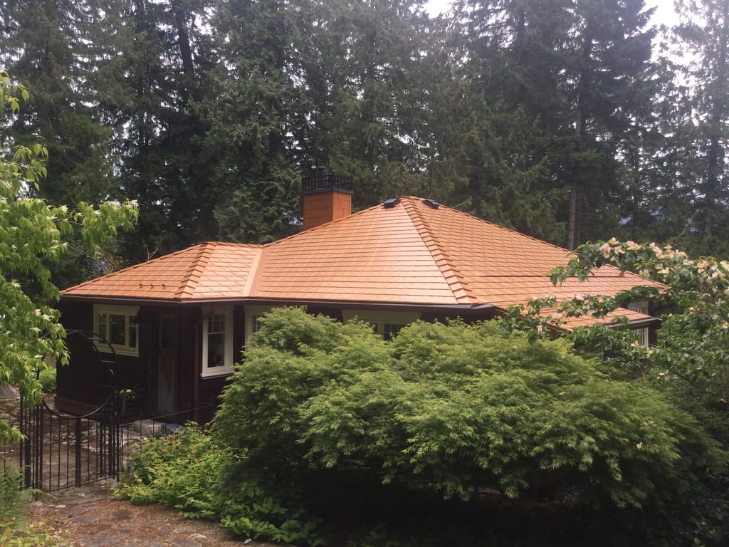 Copper Penny Interlock Slate aluminum roof on a one-storey home with a copper penny metal roof in a, Cowichan Bay, British Columbia