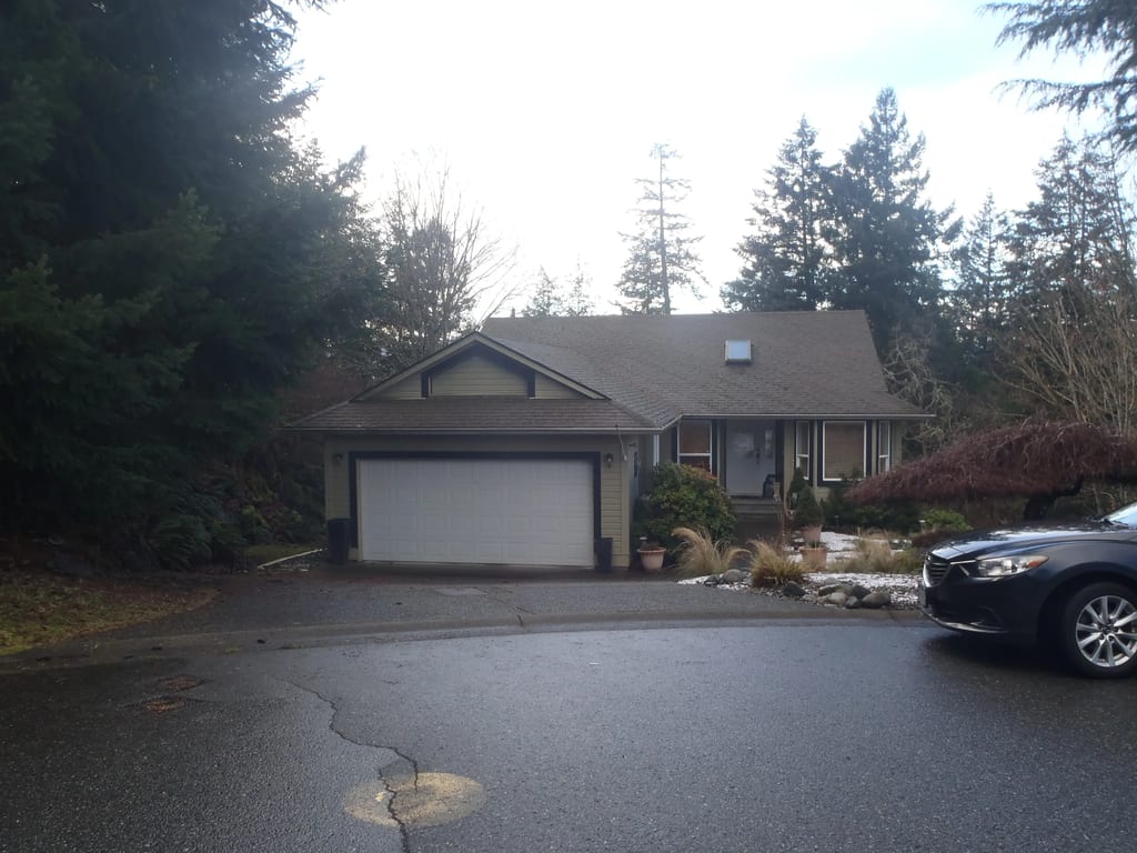 Before: a leaking asphalt shingle roof on the home, Duncan, British Columbia, ahead of a Black Interlock Slate aluminum roof