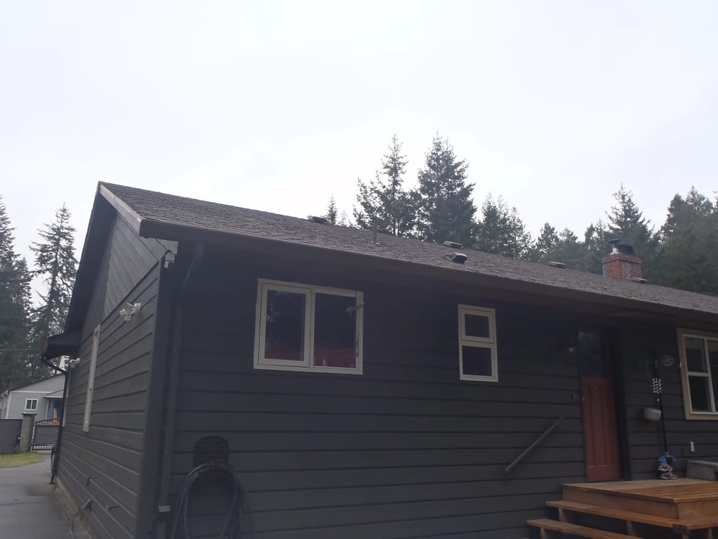 Before: a leaking asphalt shingle roof on the home, Comox, British Columbia, ahead of a Black Interlock Slate aluminum roof