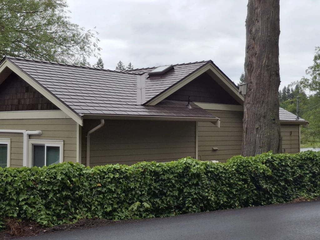 Colonial Brown Interlock Slate aluminum roof on a Colonial-style home with a Colonial Brown metal roof near, Shawnigan Lake, British Columbia