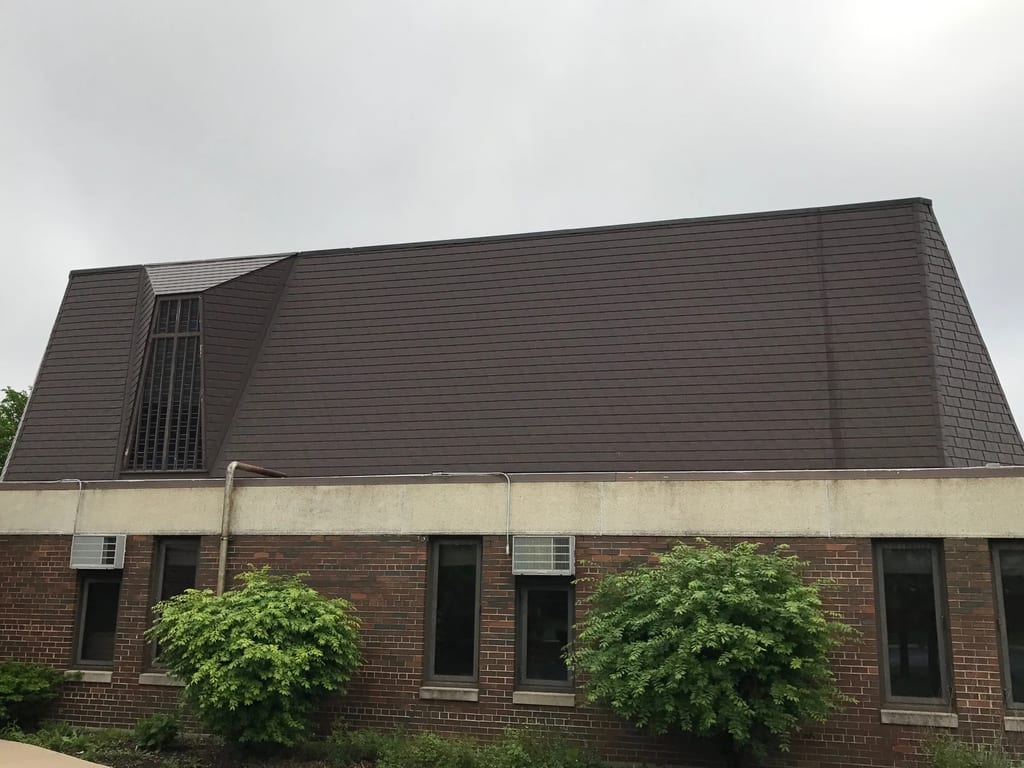 White Interlock IB Membrane aluminum roof on a red brick home with dormers in an urban area, Chicago Heights, Illinois