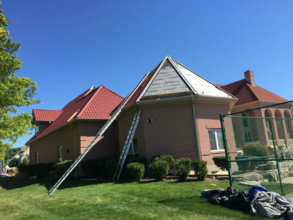 Tile Red Interlock Tile aluminum roof being installed on the home, replacing a concrete tile roof with broken tiles, South Barrington, Illinois