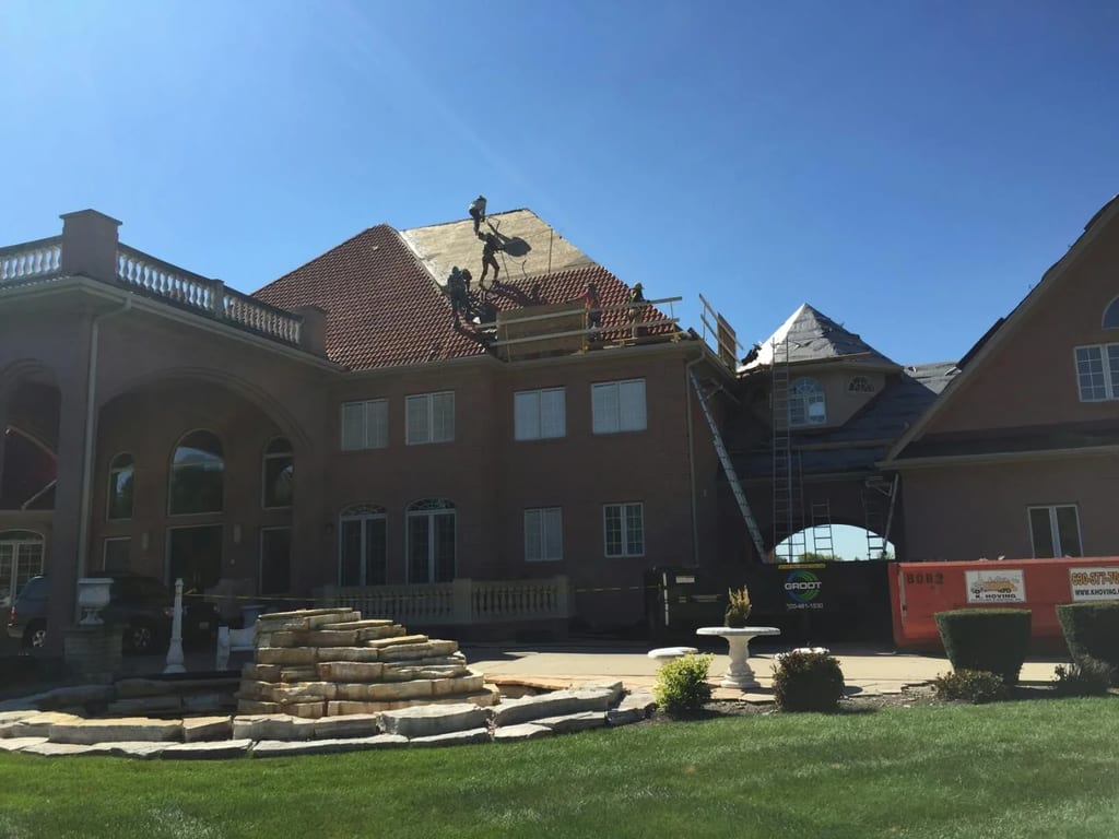 Tile Red Interlock Tile aluminum roof being installed on the home, replacing a concrete tile roof with broken tiles, South Barrington, Illinois