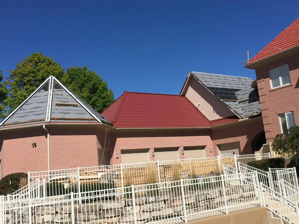 Tile Red Interlock Tile aluminum roof being installed on the home, replacing a concrete tile roof with broken tiles, South Barrington, Illinois